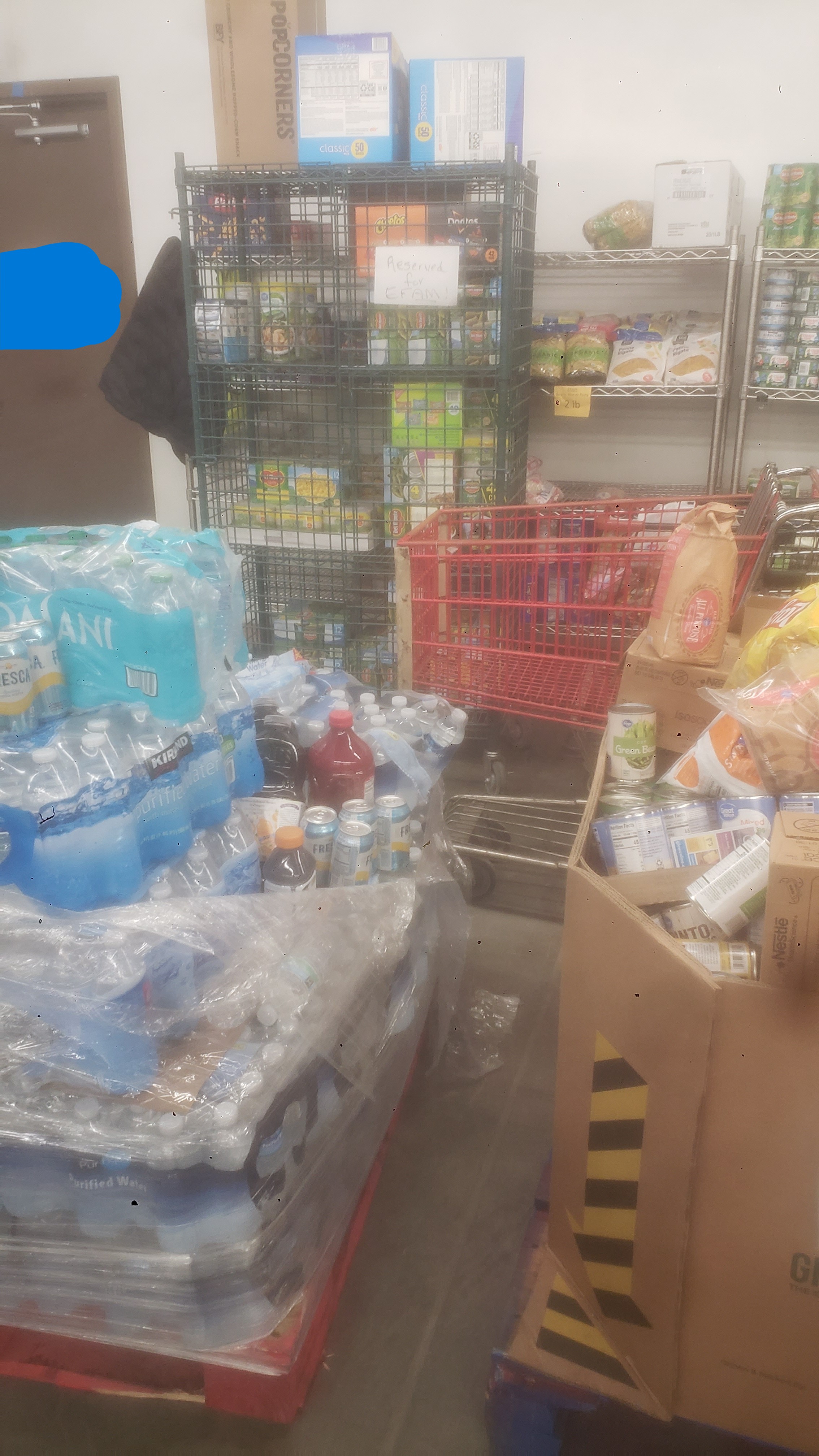 Pallets and shelves of food and drinks.